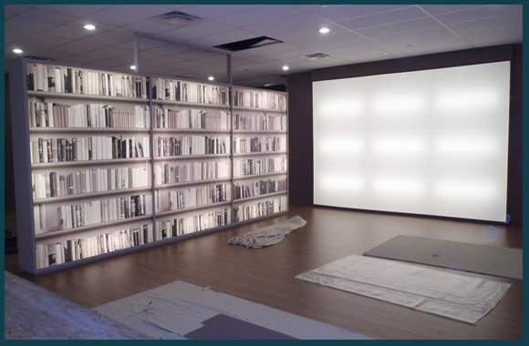Light box wall and lighted shelving floating walls in a vendor's showroom.